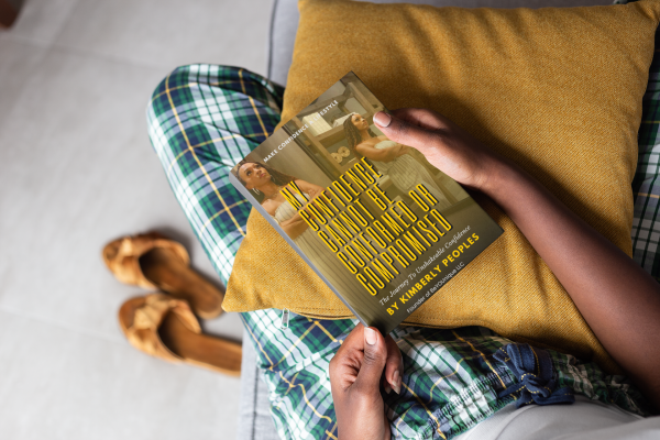 mockup-of-a-book-held-by-a-woman-s-hands-on-a-couch-23695